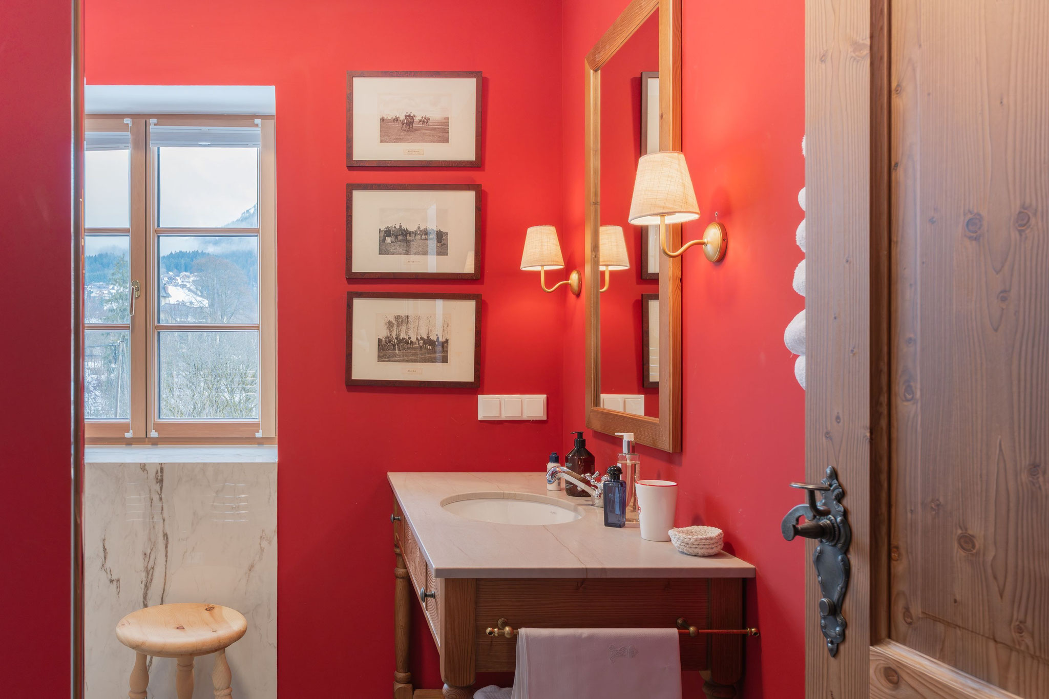 Gäste-WC in Signalrot mit historischen Jagdlithografien und Marmor-Lambris